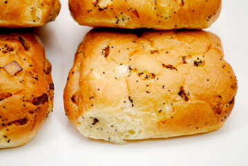 A Close-up of Onion Rolls on a White Platter	