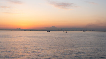Naklejka na ściany i meble Silhouette of Mt. Fuji seen from the Tokyo Bay Aqualine Umihotaru parking area