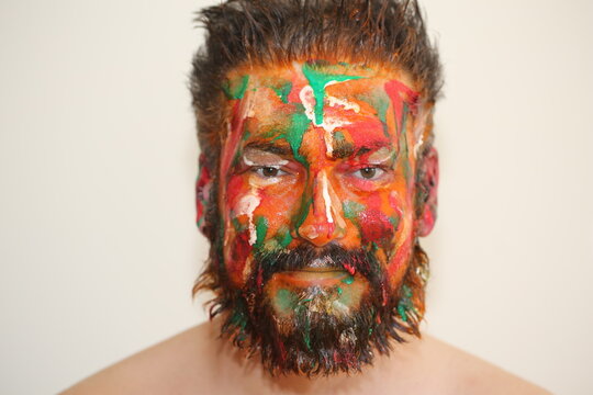 Portrait of a man colorful make up on his face different emotions