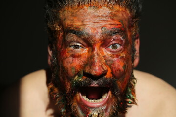 Portrait of a man colorful make up on his face different emotions