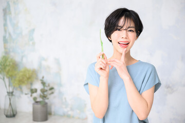 Beautiful Asian woman with toothbrush, copy space available