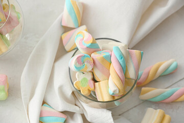 Glass with tasty marshmallows on table