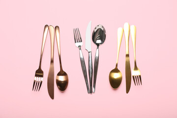 Set of different stainless steel cutlery on color background