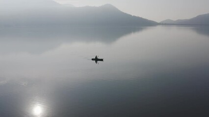 Enjoy city break alone relax rural river life on beauty fog paddling OAR rowing on calm aqua sport outside. Active solo serene people wide drone view happy get away escape summer nautical vessel trip.