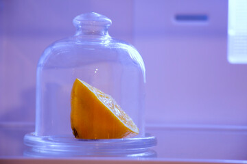 Lemon in a glass flask in the refrigerator