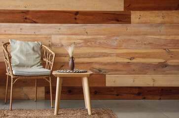 Interior of modern living room with wicker armchair and wooden coffee table