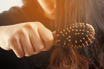 Rear view young woman worried about Hair loss problem, hormonal disbalance, stress concept. Many...
