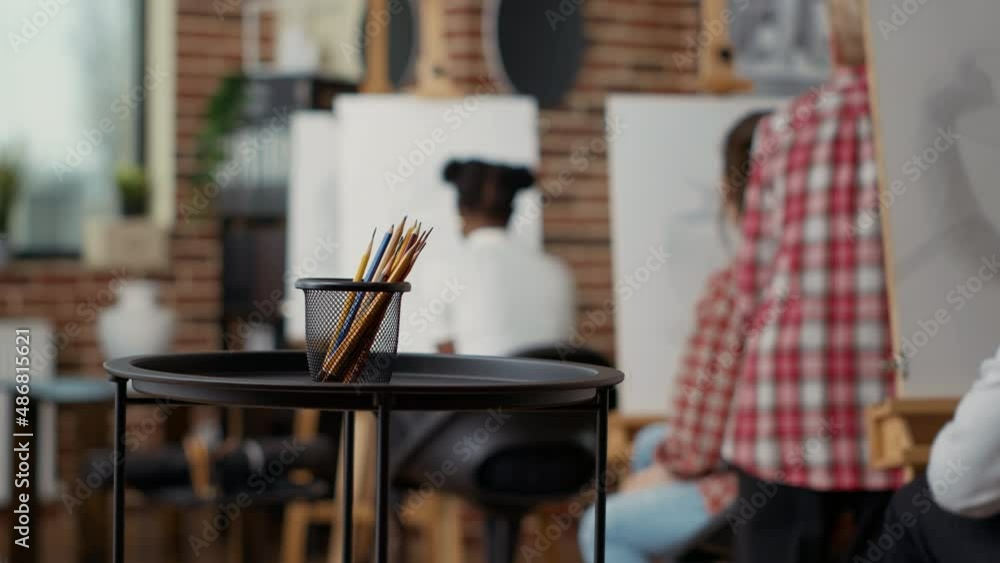 Poster Artistic tools and pencils to create sketch design on canvas with easel, using toold and equipment to draw artwork in art and craft class. Colorful drawing instruments on table. Close up