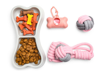 Pet toys, waste bags and food on white background