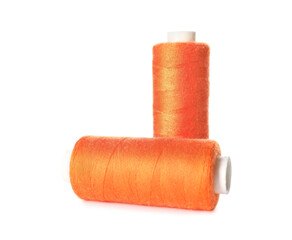 Orange sewing threads on white background