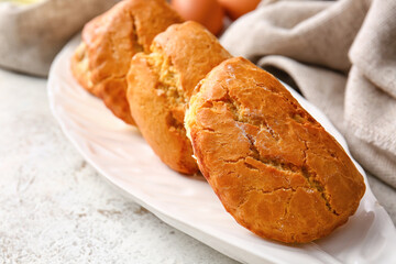 Plate of tasty sochniki with cottage cheese on light background, closeup