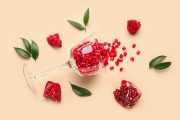 Glass with fresh pomegranate on yellow background