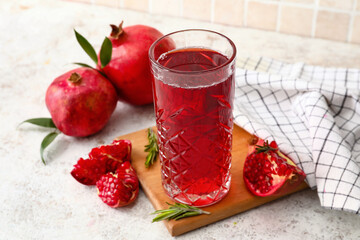Glass of delicious pomegranate juice on table