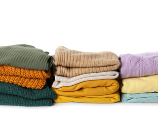 Stacks of female sweaters on white background, closeup