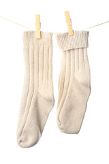 Pair of knitted socks hanging on rope against white background, closeup