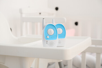 Fototapeta na wymiar Modern baby monitors on high chair in room