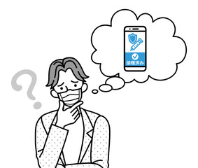 ワクチン接種証明のスマホアプリに疑問を持つマスクを着用した若い男性