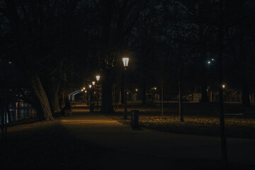 illuminated sidewalk from street lights in prague downtown at night