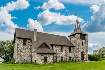 Fototapeta na wymiar Blue sky over St. Andrews Anglican stone church in Heward, SK