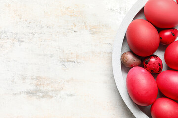 Plate with different Easter eggs on grunge background
