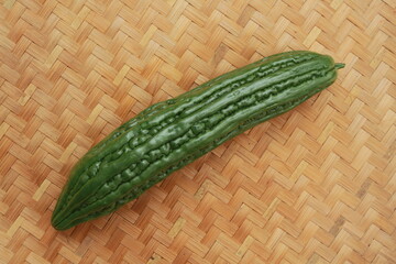 Bitter Melon (Momordica charantia) with woven bamboo on the background