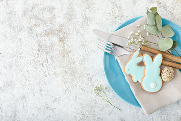Easter table setting with cookies in shape of bunny on light background, closeup