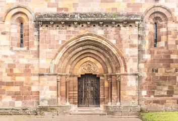 Facade of ancient stone Romanesque church entrance