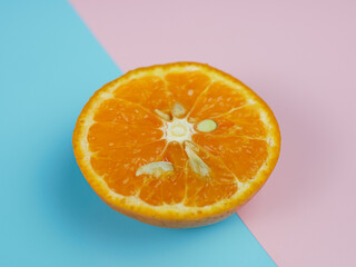 Creative concept made from oranges on blue and pink pastel background. healthy and minimal fruit concept