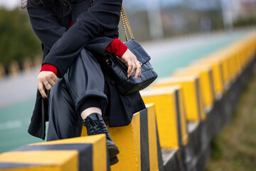 Fototapeta na wymiar An Asian woman in a black leather coat outdoors