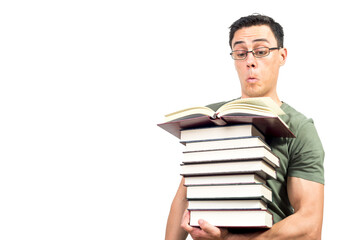 Curious male student in glasses reading interesting books