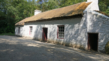 Old Irish Traditional Whitewashed Cottage with thatched roof on a Farm in Ireland