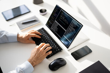 Computer Programmer Writing Program Code On Computer