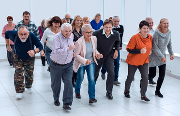 jogging old happy friends. close-up marathon of mature people