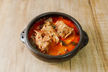 Gamjatang, Korean style Pork Back-bone Stew : A thick soup made of pig backbones, potato, green cabbage leaves (ugeoji), crushed perilla seeds, perilla leaves, spring onions, and garlic. A spicy dish 