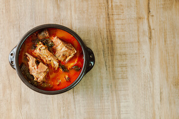 Gamjatang, Korean style Pork Back-bone Stew : A thick soup made of pig backbones, potato, green cabbage leaves (ugeoji), crushed perilla seeds, perilla leaves, spring onions, and garlic. A spicy dish 