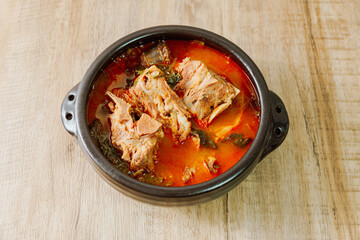 Gamjatang, Korean style Pork Back-bone Stew : A thick soup made of pig backbones, potato, green cabbage leaves (ugeoji), crushed perilla seeds, perilla leaves, spring onions, and garlic. A spicy dish 