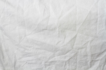 Wrinkled sheet. White fabric close-up. Burlap texture. Sheet on the bed.