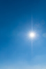 Beautiful shining sun at clear blue sky