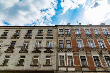 Fototapeta premium Facade of two old block of flats at sunny cloudy day