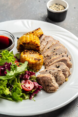 Green salad with chicken breast, grilled corn and sauce. Healthy fats, clean eating for weight loss