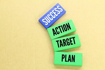 colored wooden boards with the words Plan target action and success