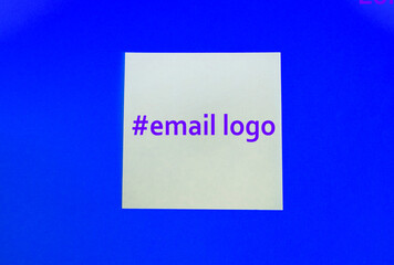 at and hashtag symbols crafted in wood and photographed on a dark stone textured surface.