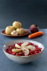 Salad of fermented apples with raw beets and carrots. Soaked or pickled apples are a traditional Russian dish.