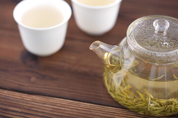 A pot of green tea and two cups