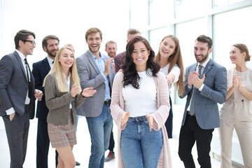 happy woman leader on the background of her business team