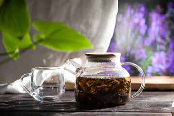 Transparent teapot with hot Koporye tea, traditional Russian drink