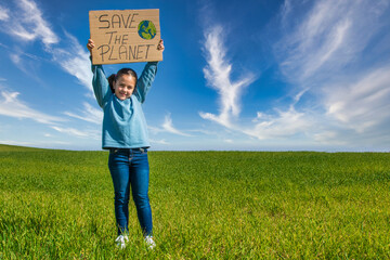 Beautiful Little girl In A Green Field With A Nice Blue Sky,  Holding A Cardboard Sign That Says...