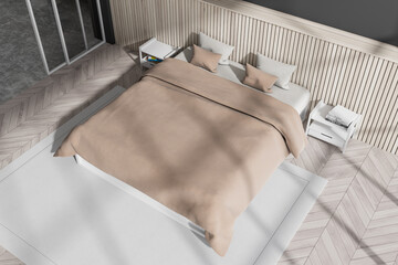 Top view of bedroom interior with bed and nightstand, carpet