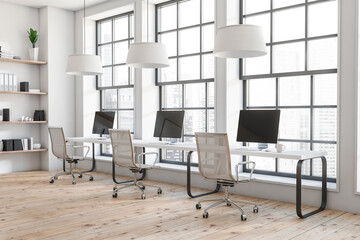 Business room interior with seats, table with desktop, window with city view
