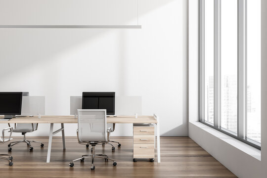 Office room interior with seats, table and computers, window with city view